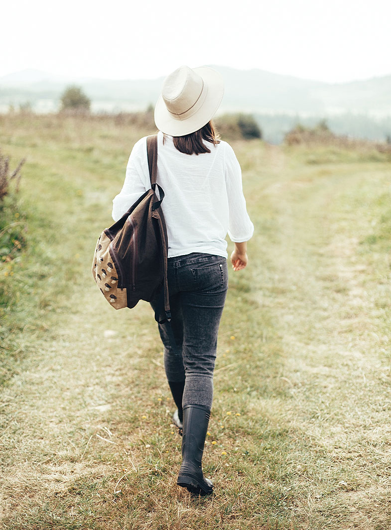 woman walking outdoors representing clarity and progress after health coaching
